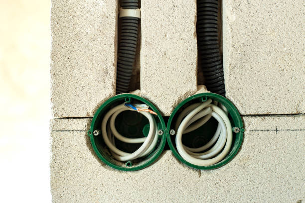 istock New electrical wiring installation, plastic boxes and electrical cables for future outlet sockets on the wall, renovation concept. 1319312746