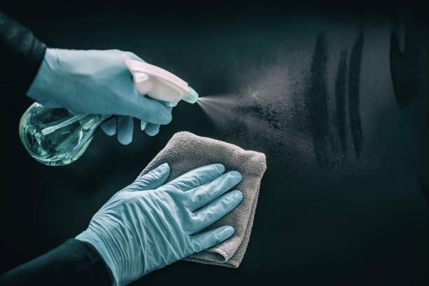 istock Cleaning surfaces as coronavirus infection spreading prevention. Clean surface hygiene in public spaces, offices, hospital for healthcare workers disinfecting home with medical PPE blue gloves 1319314194