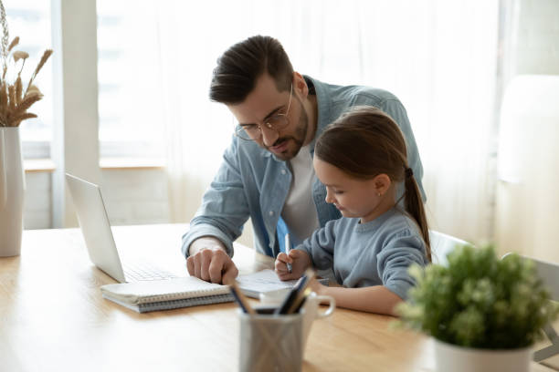 istock Caring father help little daughter with homework 1319314633