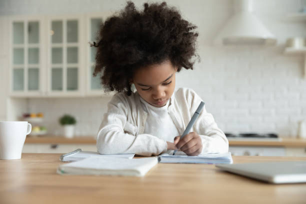 istock African American little girl study alone at home 1319314650