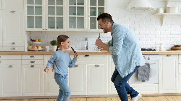 istock Overjoyed dad have fun dance with small daughter 1319314667