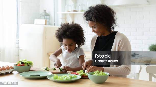 Happy Biracial Mom And Little Daughter Cook Together Stock Photo - Download Image Now