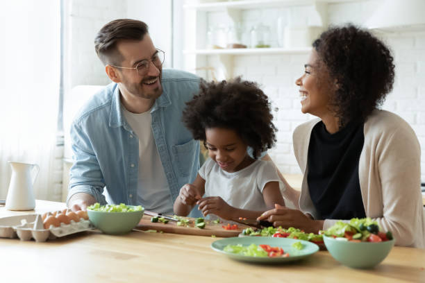 istock Happy multiethnic family with kid cook together 1319314686