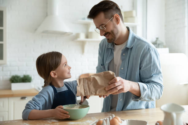 istock Happy young father baking with little daughter 1319314732