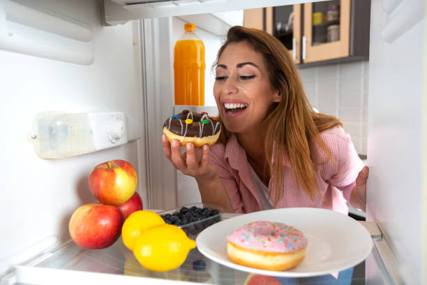 istock Young pretty woman decides it is time for some sugar and sweets from the fridge 1319316734