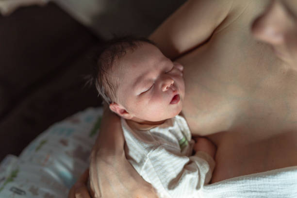 istock Sleeping Baby In Mothers Arms After Breastfeeding 1319318570