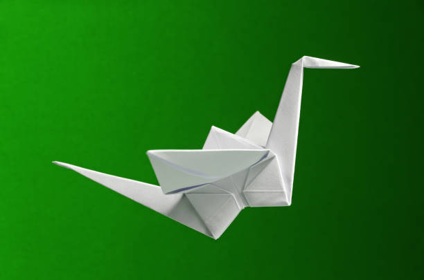 istock White Origami On Green Background 1319321429