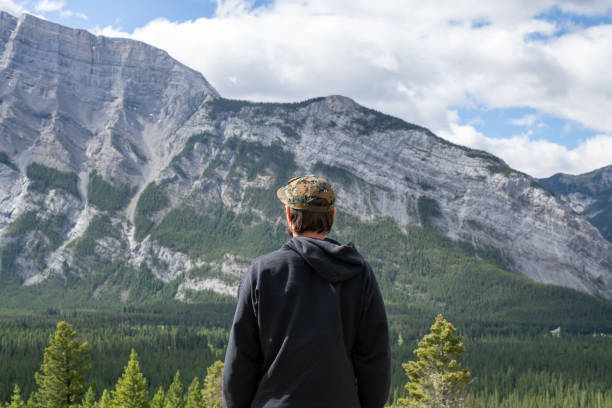 Summer hike in the mountains with a backpack and tent.
