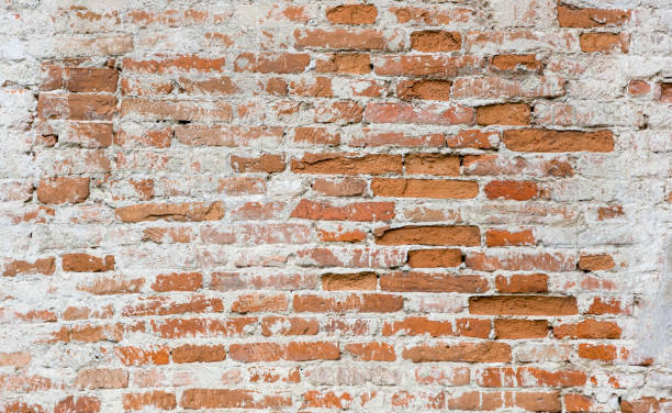 istock Brick old wall. Cleaned plaster. Red brick. Brick wall of old bricks. 1319327041