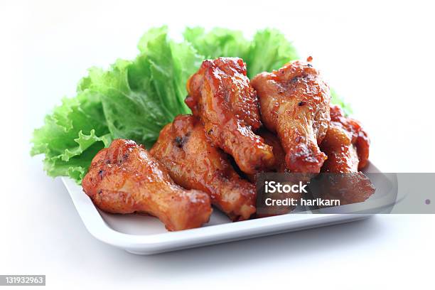 Bbq Glazed Wings Served On A White Plate With Lettuce Stock Photo - Download Image Now