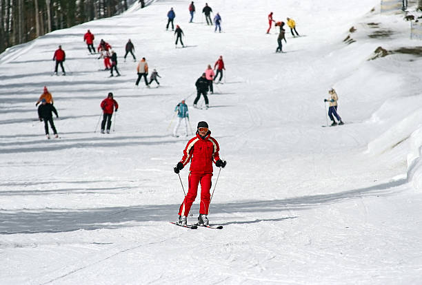 Female skier on slope for beginners stock photo
