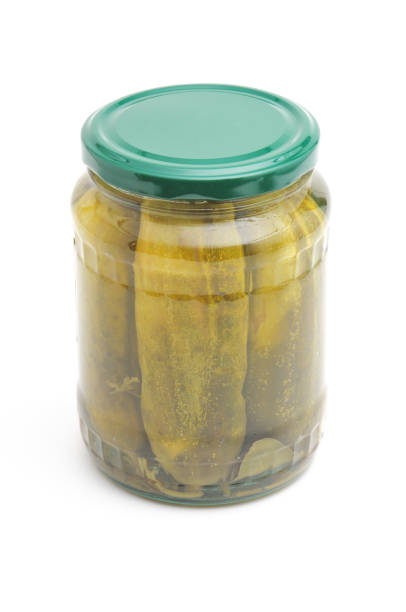 istock Pickled cucumbers in a glass jar on a white background 1319331177