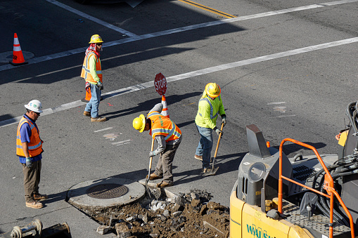 Santa Ana, CA - May 21, 2021: Road workers performing maintenance and repair on public street