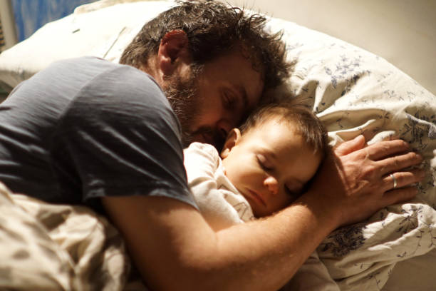 istock father and baby sleeping 1319332513