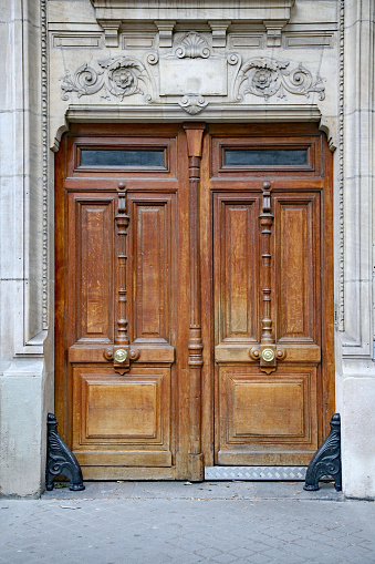 Carved wooden double door, commonly found as entrance to European apartment buildings