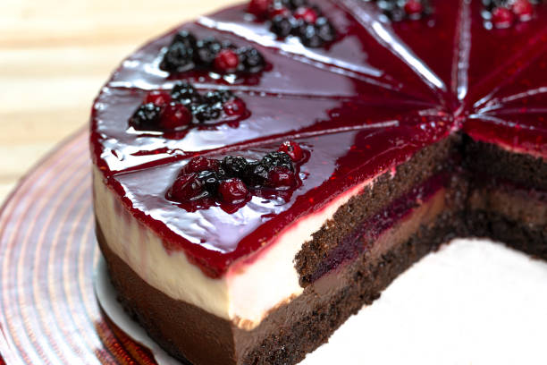 Forest fruit and chocolate cake with small pieces of fruit on it.