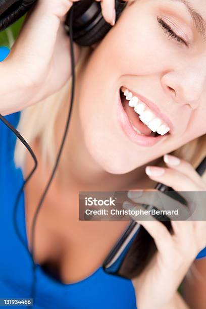 Smiling Woman Listening To Music Stock Photo - Download Image Now - 20-24 Years, 25-29 Years, Adult