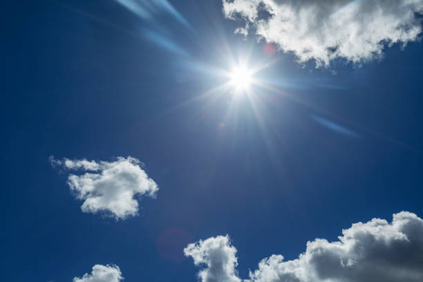 istock white cloud in blue sky with shinning sun 1319351067