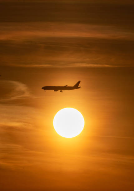 istock Aeroplane crossing the sun 1319352811
