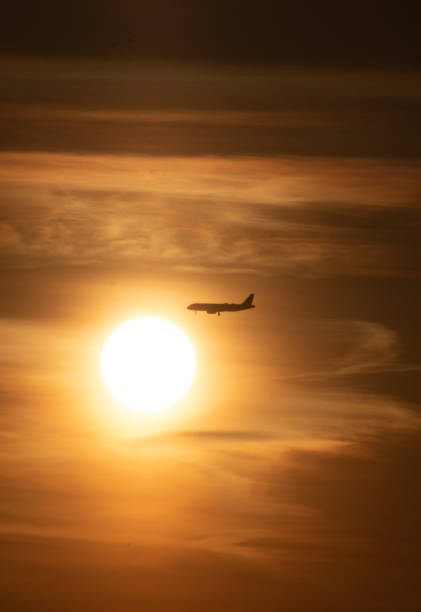 istock Aeroplane crossing the sun 1319352814