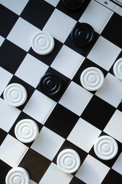 Board game of checkers. Black and white chips for the game.
