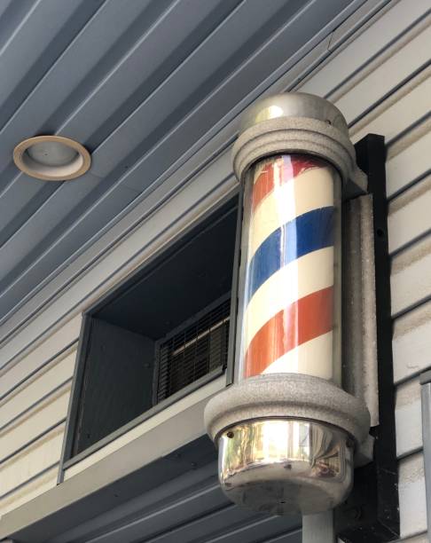 istock Barbershop Pole on Gray Building 1319354118
