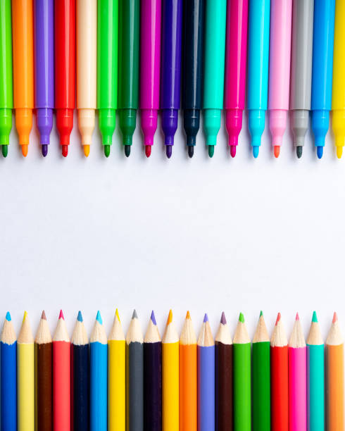 istock Colored pencils and markers on a sheet of white paper. Selective focus. Backgrounds and textures. 1319355447