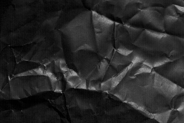 istock Grunge wrinkled black color paper textured background 1319357784