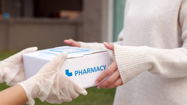 Asian female patient receive medication package box free first aid from pharmacy hospital delivery service at home wear glove in telehealth, telemedicine healthcare insurance online concept. Asian female patient receive medication package box free first aid from pharmacy hospital delivery service at home wear glove in telehealth, telemedicine healthcare insurance online concept. pharmacy photos stock pictures, royalty-free photos & images