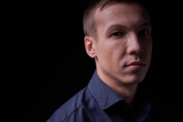 istock Beautiful young guy on a black background in the Studio 1319364754