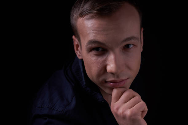 istock Beautiful young guy on a black background in the Studio 1319364775