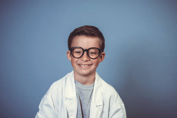 istock cool school boy with thick black glasses is dressed as mad scientist with white coat 1319366555