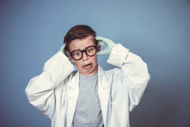 istock cool school boy with thick black glasses is dressed as mad scientist with white coat 1319366599