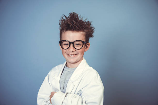 istock cool school boy with thick black glasses is dressed as mad scientist with white coat 1319366607