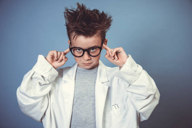 istock cool school boy with thick black glasses is dressed as mad scientist with white coat 1319366655