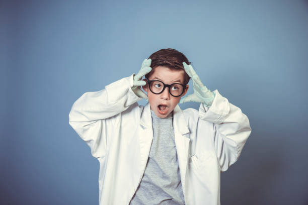 istock cool school boy with thick black glasses is dressed as mad scientist with white coat 1319367331