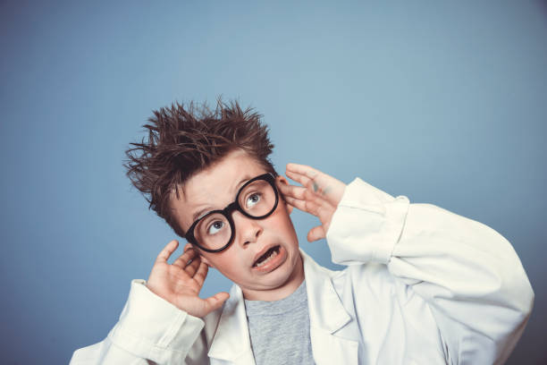 istock cool school boy with thick black glasses is dressed as mad scientist with white coat 1319367485