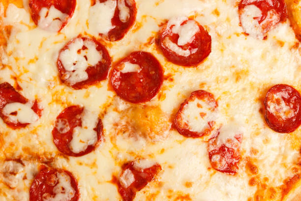 istock Baked pizza with cheese, tomatoes and mushrooms 1319368693