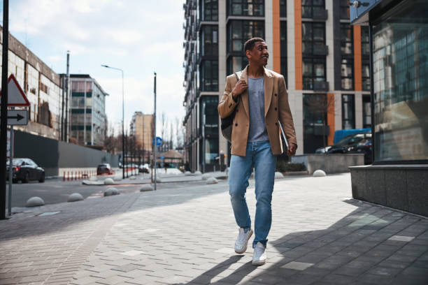 istock Relaxed young man walking down the street 1319376276