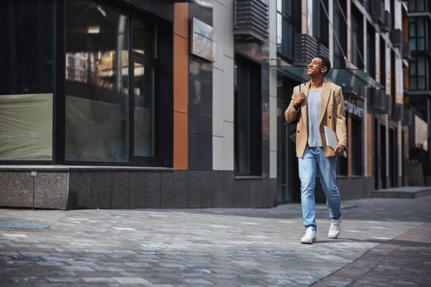 istock Joyful dark-skinned male looking for the entrance 1319376281