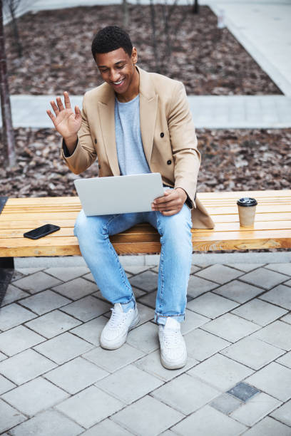 istock Young happy freelancer communicating with friend online 1319376333