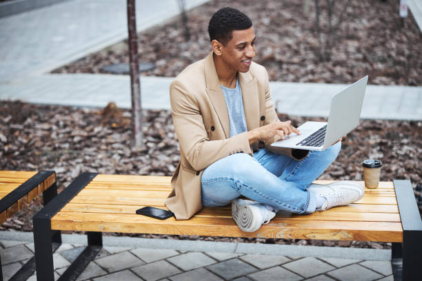 istock Positive delighted male person using his laptop 1319376859