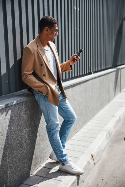 istock Delighted dark-skinned male person reading income message 1319376914