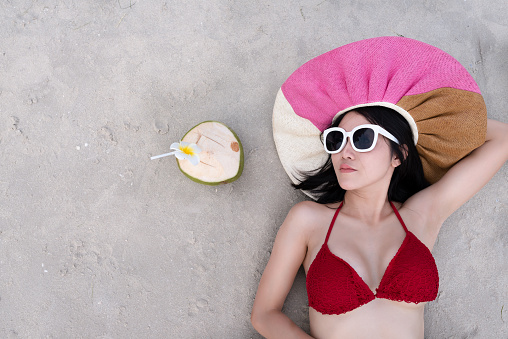 Sexy woman in the red bikini and sunhat on sea beach.travel summer beach