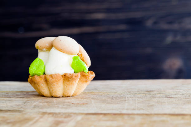 sweet and delicious shortbread dough and a large amount of cream from which they made decorations for dessert in the form of mushrooms, a close-up of a sweet and delicious dessert