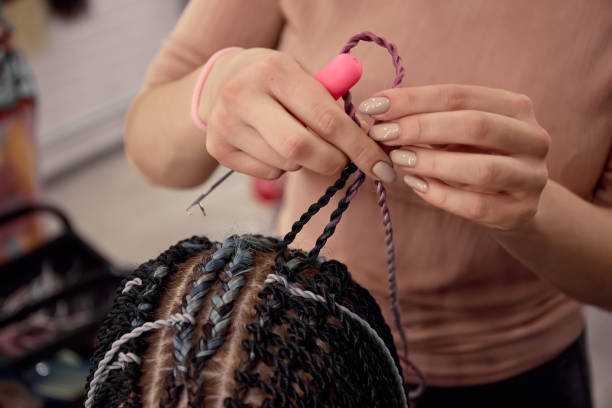 Beauty salon master works, Afro-braids and dreadlocks stock photo