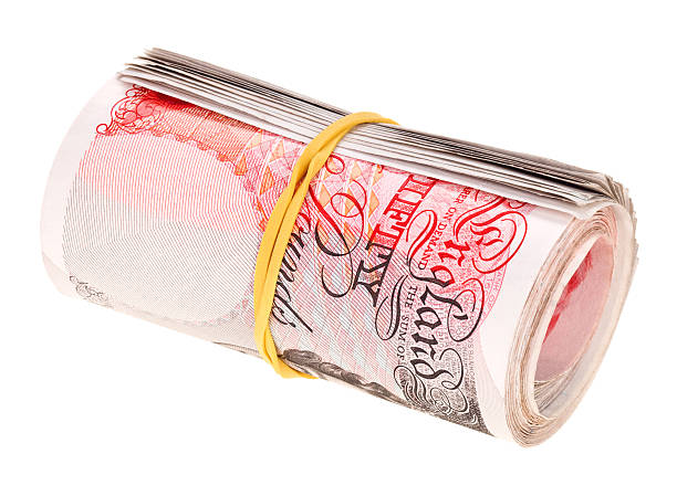 Pound sterling rolled up 50 bank notes, isolated on white