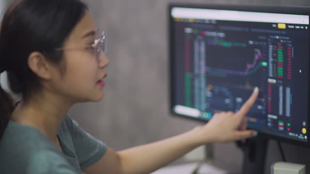 Young Asia Financial planner female using computer working at home office