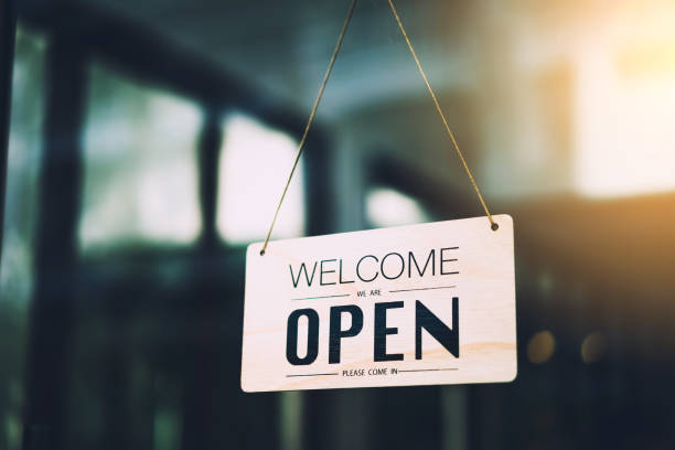 istock Open sign hanging front of cafe with colorful bokeh light abstract background. 1319388345