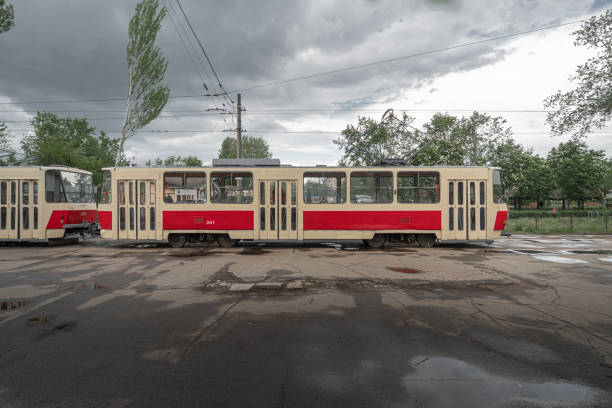 Ostrava, Czech - 26 04 2015: Blackwhite image - Exhibition of old red Ostravian tram from communistic age with Czech and Soviet flags in a street lined by beautiful trees.